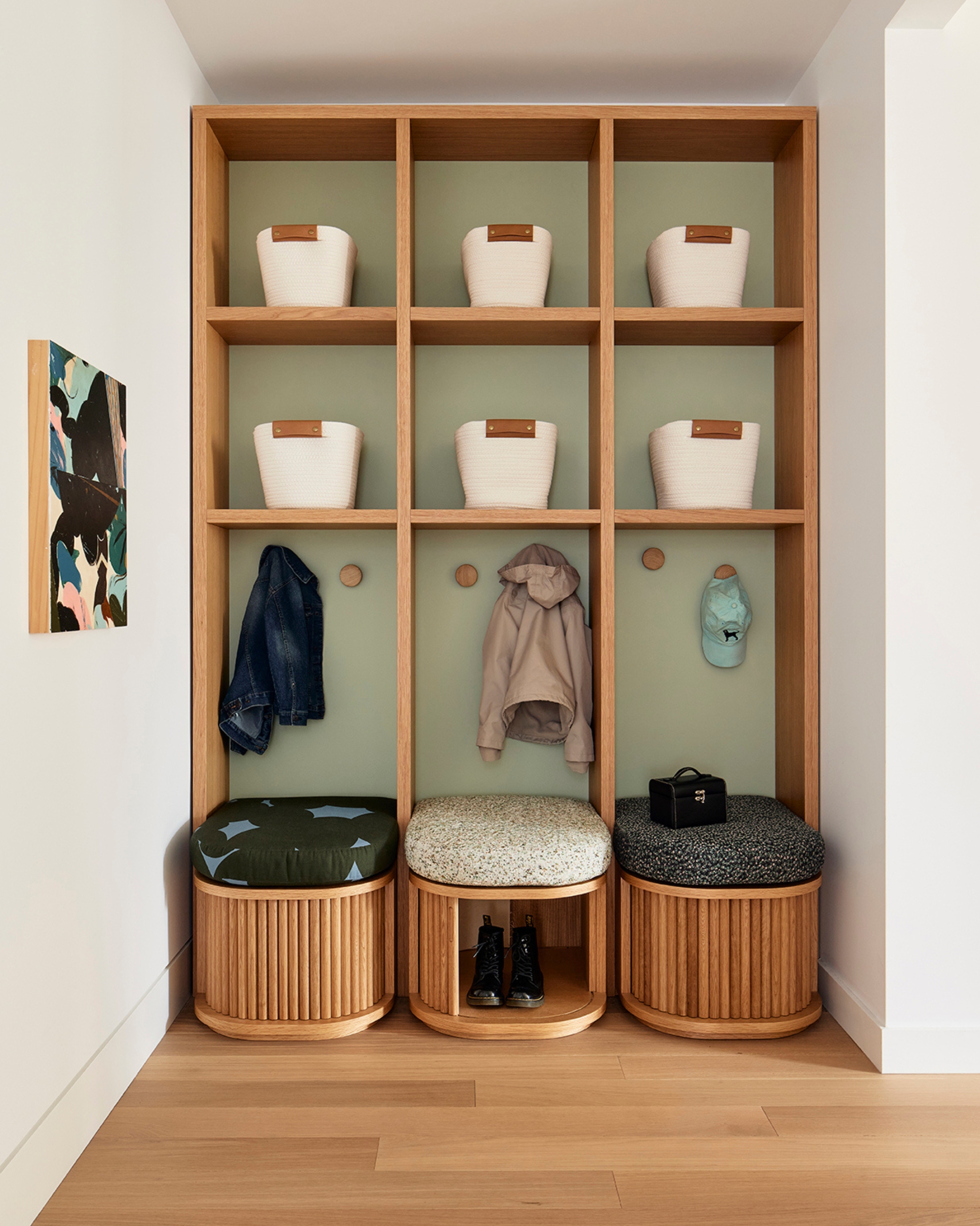 an entryway seating area with tambour doors to hide shoes