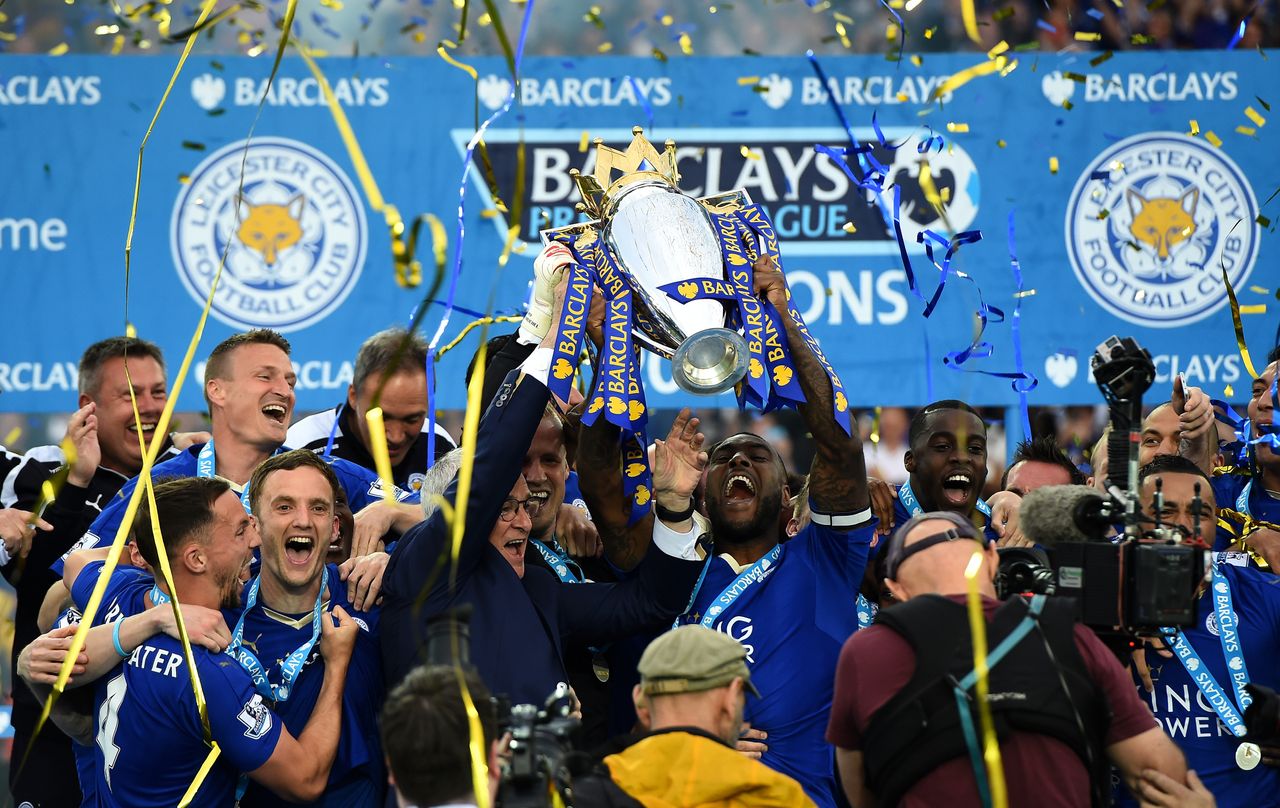 LEICESTER, ENGLAND - MAY 07:Captain Wes Morgan and manager Claudio Ranieri of Leicester City lift the Premier League Trophy after the Barclays Premier League match between Leicester City and