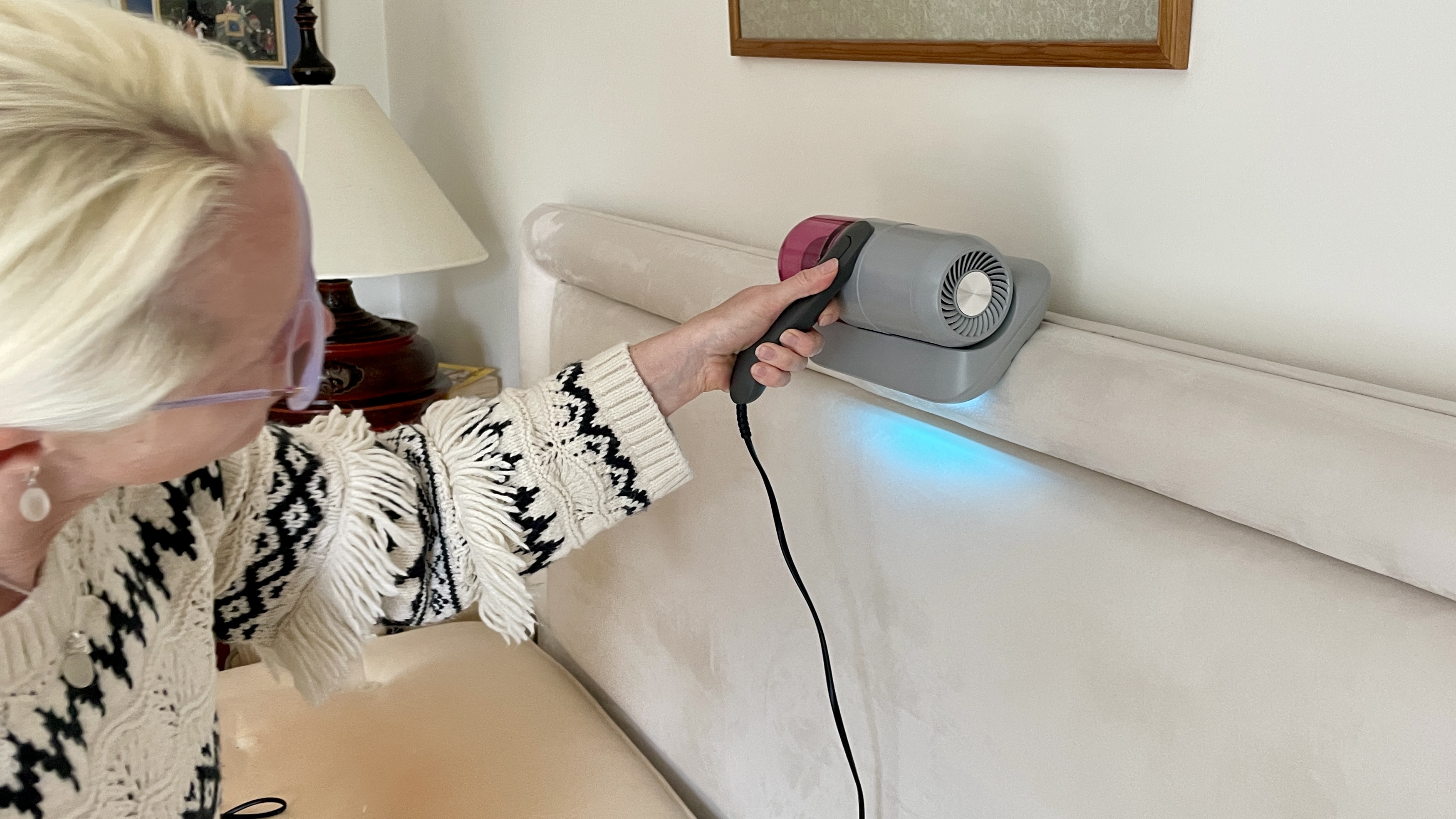 Ambiano mattress vac on a headboard, with UV light showing