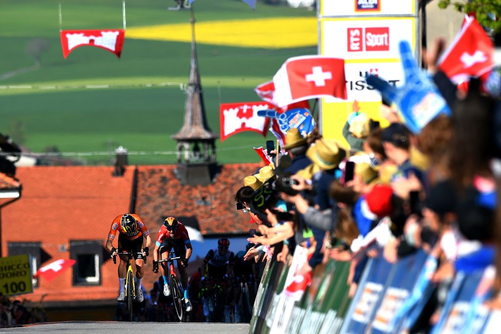 ROMONT SWITZERLAND APRIL 27 LR Dylan Teuns of Belgium and Team Bahrain Victorious sprints to beat Rohan Dennis of Australia and Team Jumbo Visma orange points jersey during the 75th Tour De Romandie 2022 Stage 1 a 178km stage from La Grande Beroche to Romont 777m TDR2022 on April 27 2022 in Romont Switzerland Photo by Dario BelingheriGetty Images