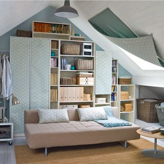 space saving attic living room with wooden shelves and cane basket