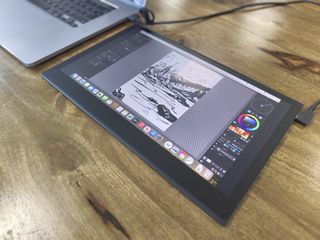 Wacom Movink review; a pen display on a wooden table connected to a laptop