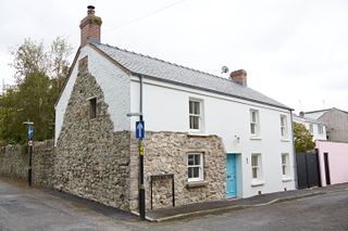 partially rendered house with exposed stone