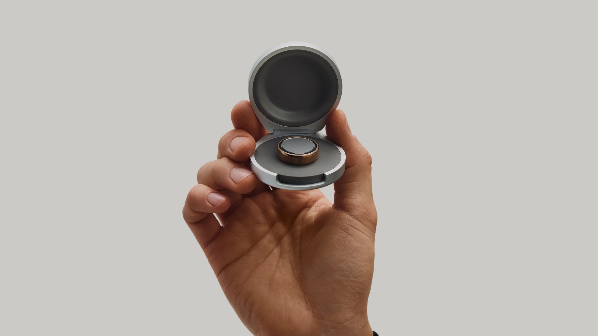 Oura Ring 5 charging case held up to camera
