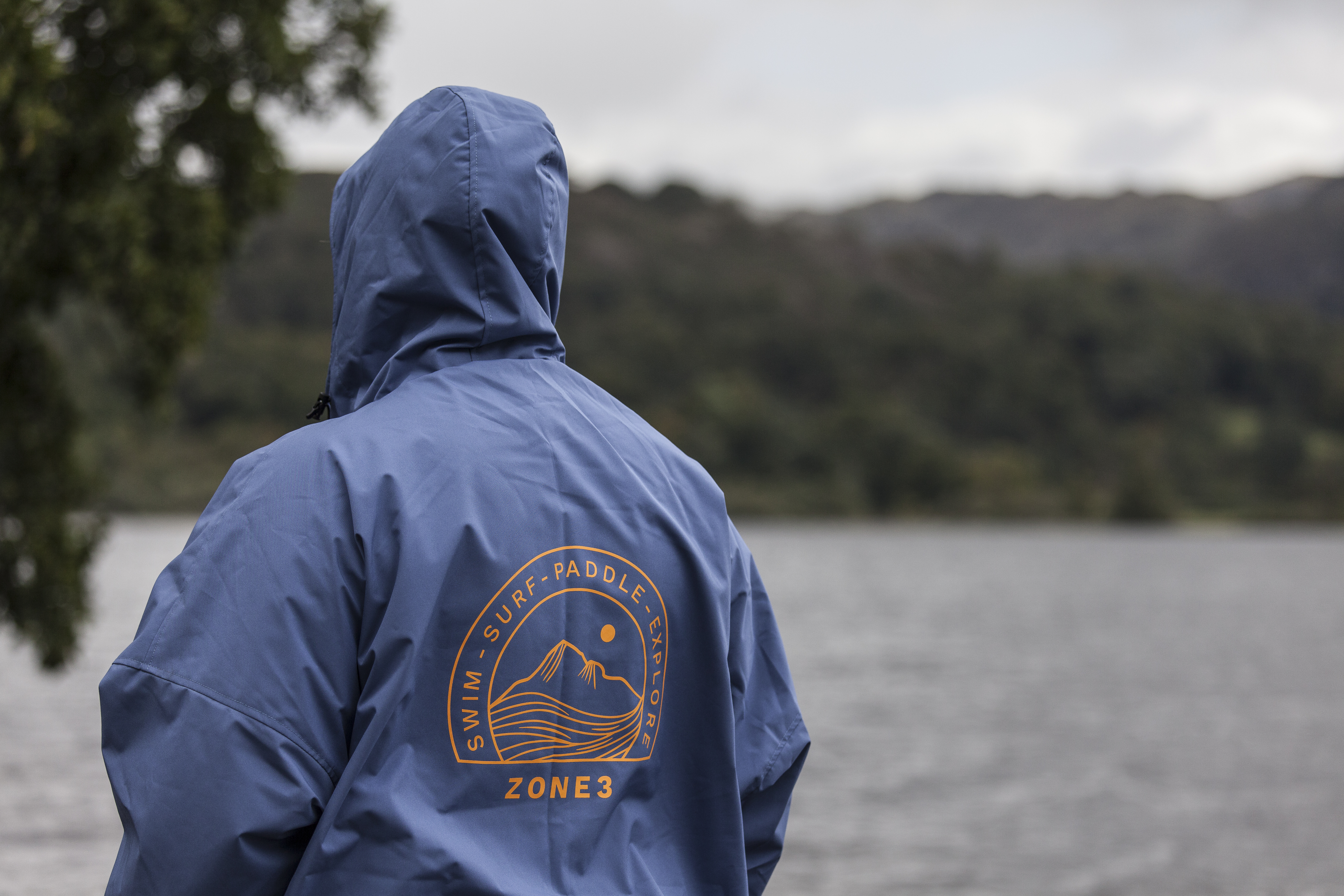 Woman standing in Grasmere lake wearing Zone3 thermotech changing robe