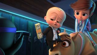 Ted holds out a wad of cash to a character off camera in The Boss Baby movie