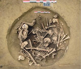 In 2012, researchers reported finding a deep pit filled with limbs of infants, children and adults with several skeletons dumped on top of the pile.