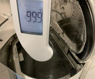 An electric thermometer measuring the temperature of the water in the Aarke Kettle.
