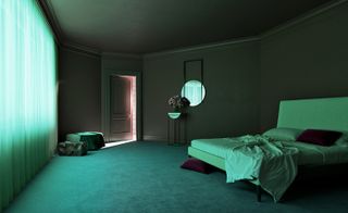 A 3D render of a room. A large, unmade bed, with a white headboard, sits to the right. A circular mirror hangs above the metal and white marble table with a vase with flowers in it sits below it. To the left, there is a door that leads to the bathroom.