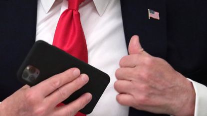 Donald Trump pockets his phone