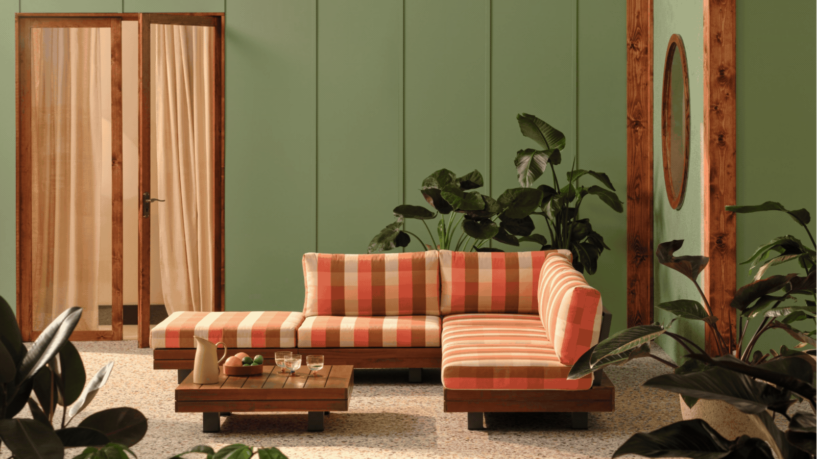 A rotating GIF of different living rooms with patterned rugs and sofas. 
