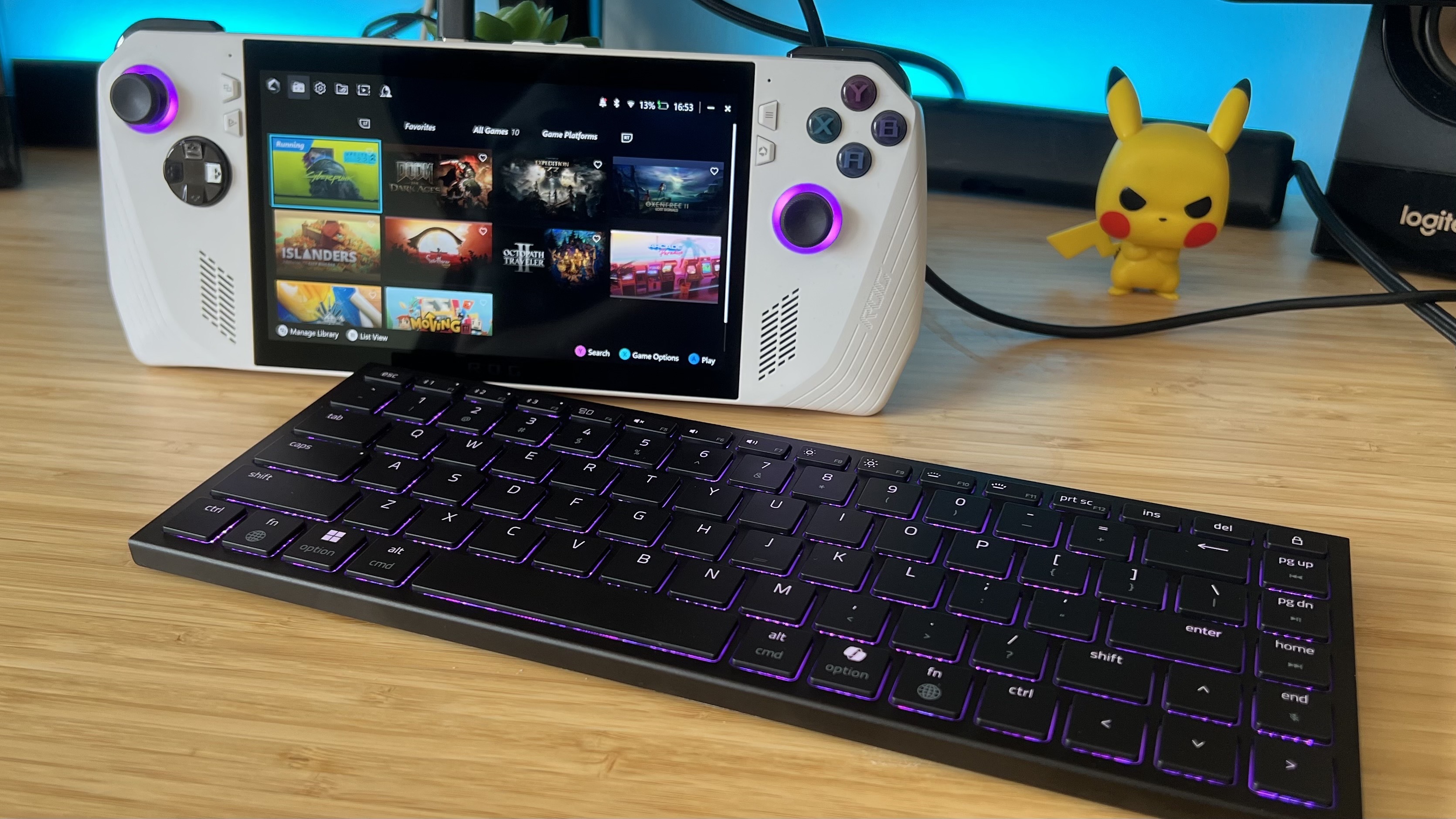 Razer Joro gaming keyboard with Asus ROG Ally on a wooden desk