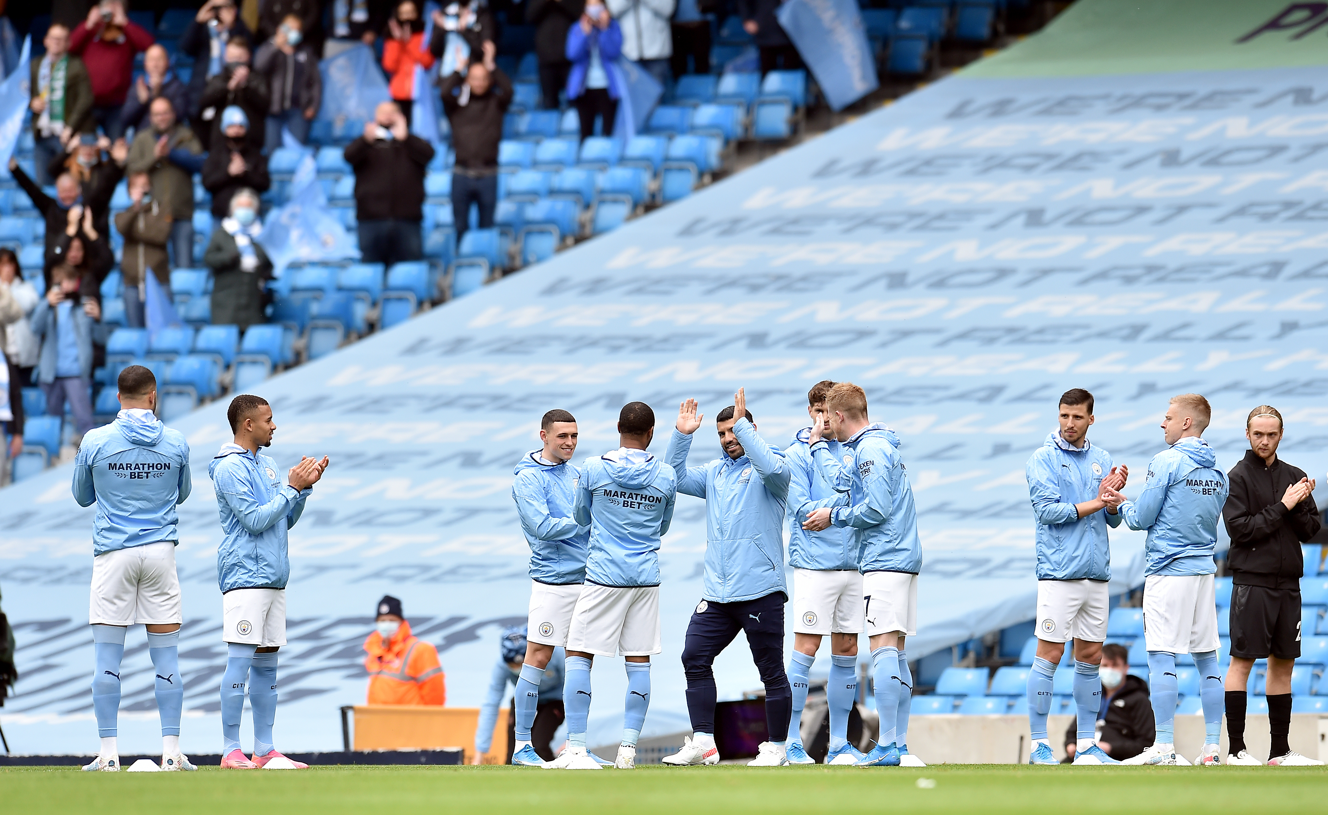 Sergio Aguero gets a guard of honour before the game
