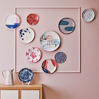 Plates displayed on pink wall