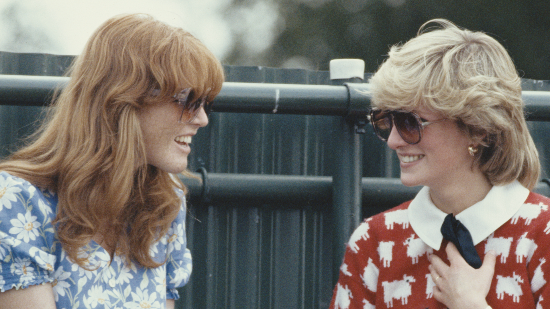 Sarah Ferguson talking to Princess Diana, wearing a red sheep sweater