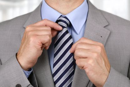 Man tightens necktie
