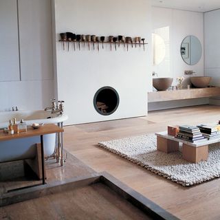 bathroom with wooden floors and white wall