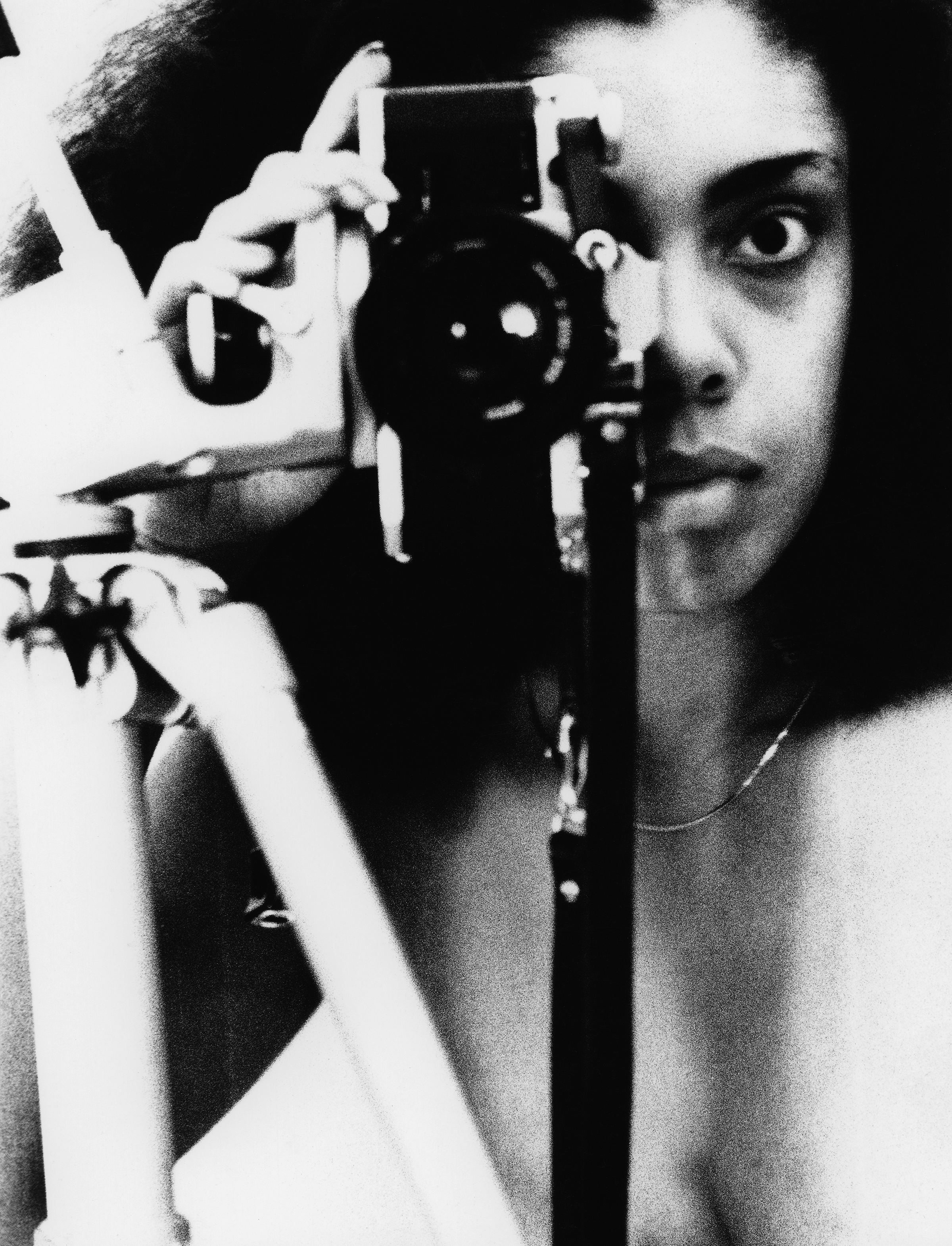 Self-portrait of Coreen Simpson holding camera to face