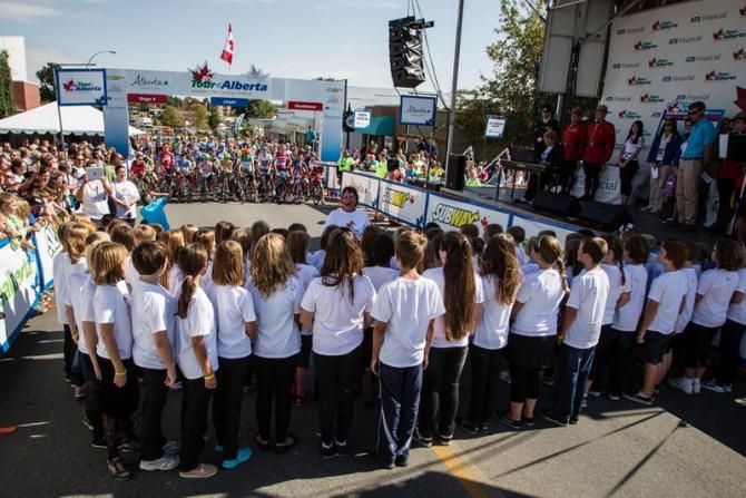 Children sing the Canadian national anthem for today's stage start in Strathmore.