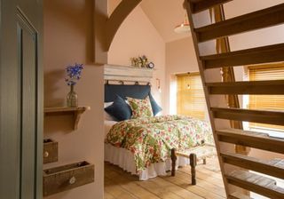 bedroom with wooden floor and wooden ladder