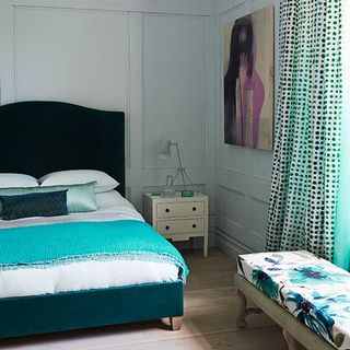 bedroom with teal and green beddings