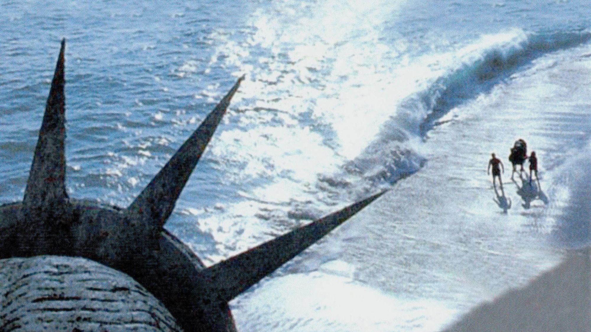 Statue of Liberty head on a beach with people standing in the waves in Planet of the Apes