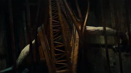 Pyramid Head crashing through iron bars in Return to Silent Hill