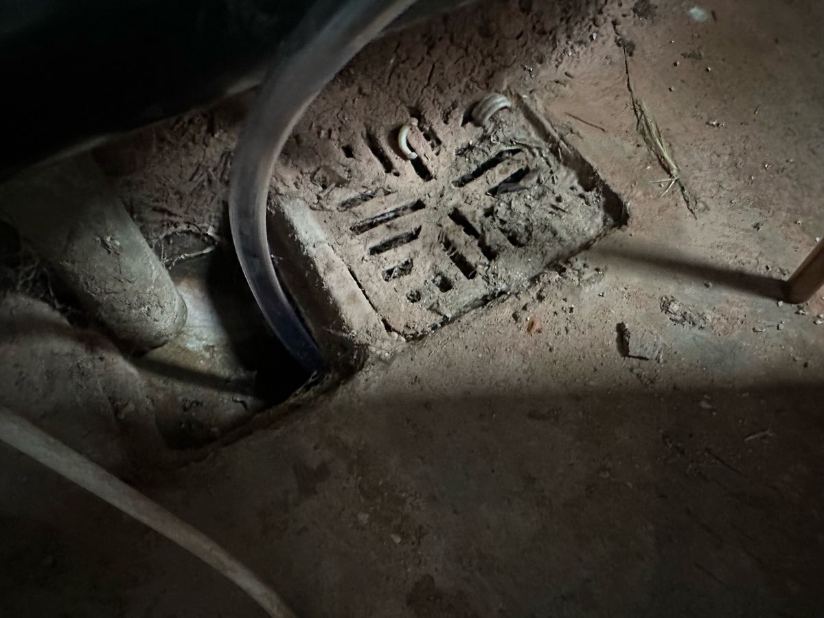 The water drainage tube from the dehumidifier inserted into a drain