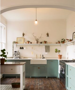 blue and white kitchen with archway and open shelving