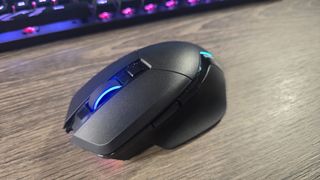Powercolor Alphyn AM10 Wireless Gaming Mouse with RGB enabled on a desk.