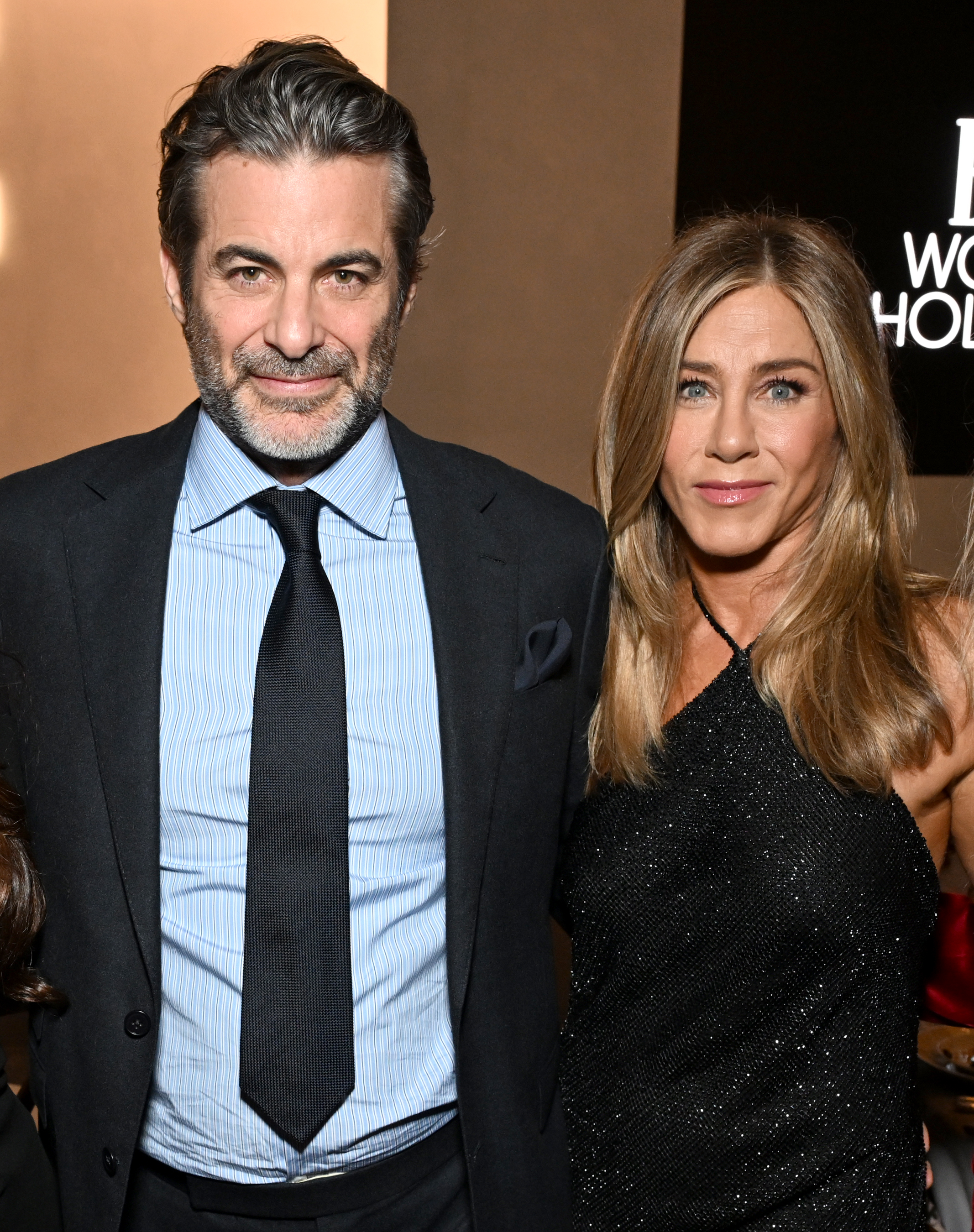 Jim Curtis in a black suit and light blue shirt and Jennifer Aniston in a sparkly black dress attend ELLE's 2025 Women in Hollywood Celebration on November 17, 2025 in Los Angeles, California