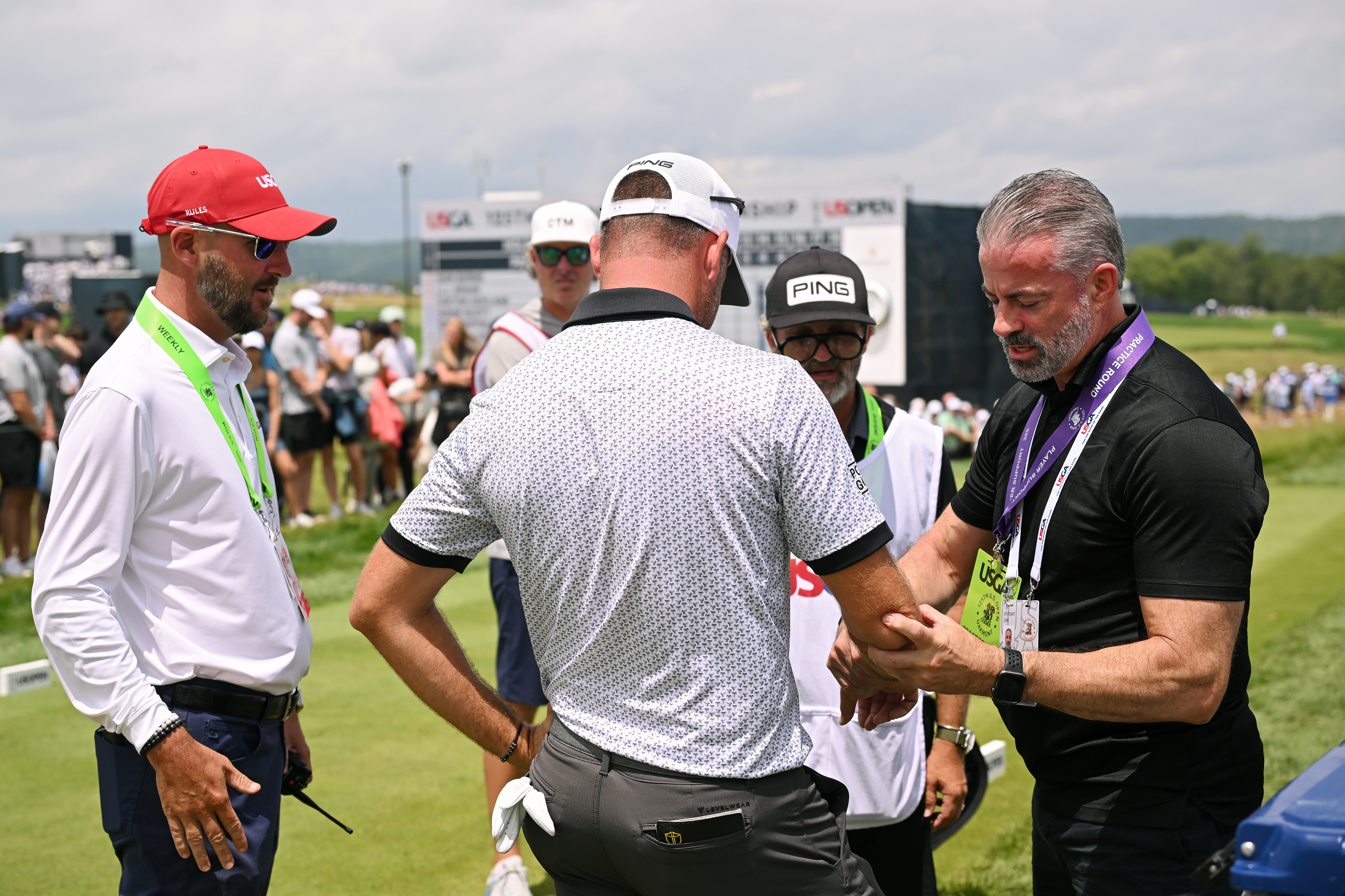 Corey Conners getting his wrist worked on during the US Open