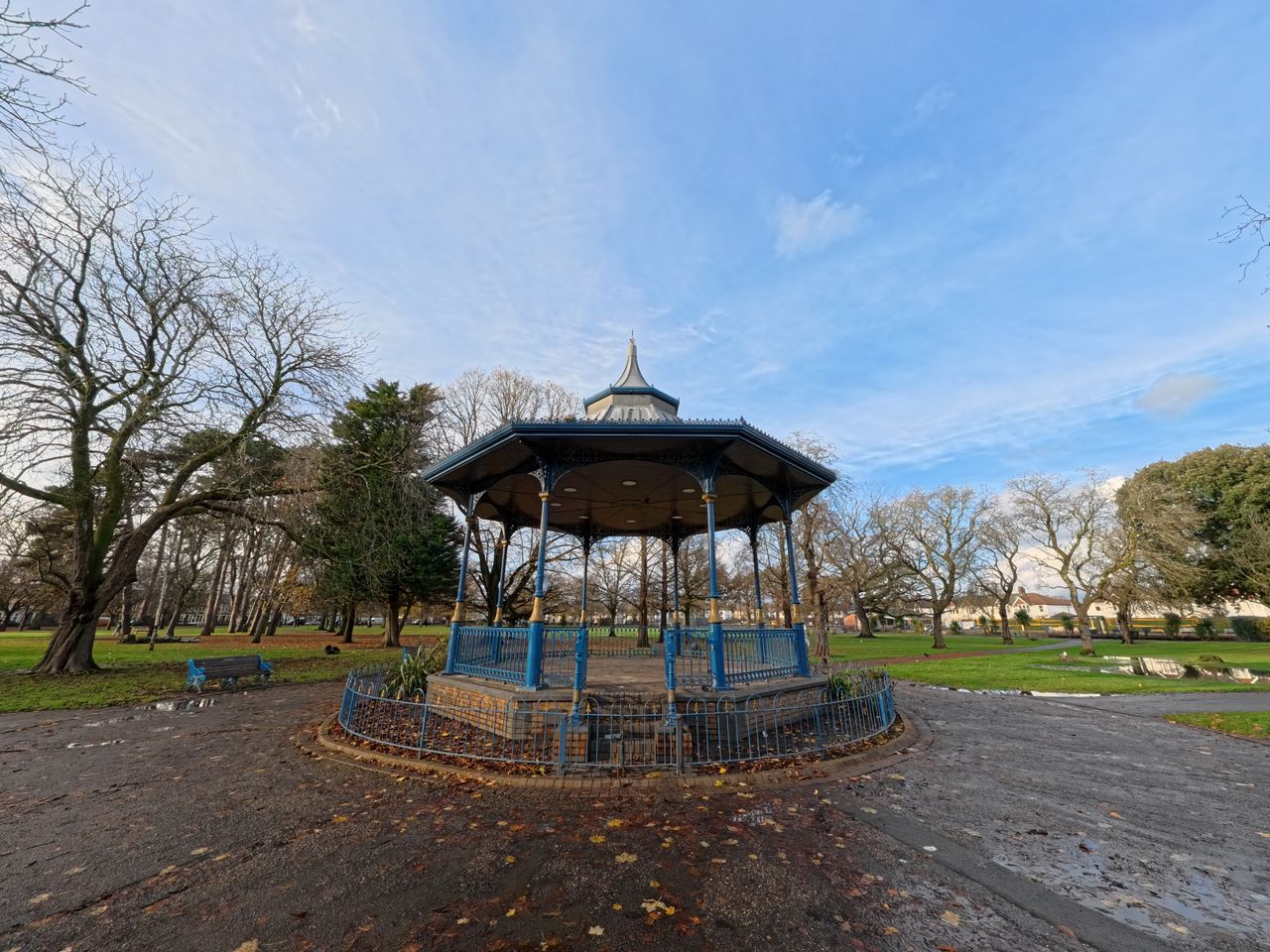 A photo of a pavilion in a park with trees and a blue sky in the background. Shot on the Insta360 Ace Pro in Linear FoV.
