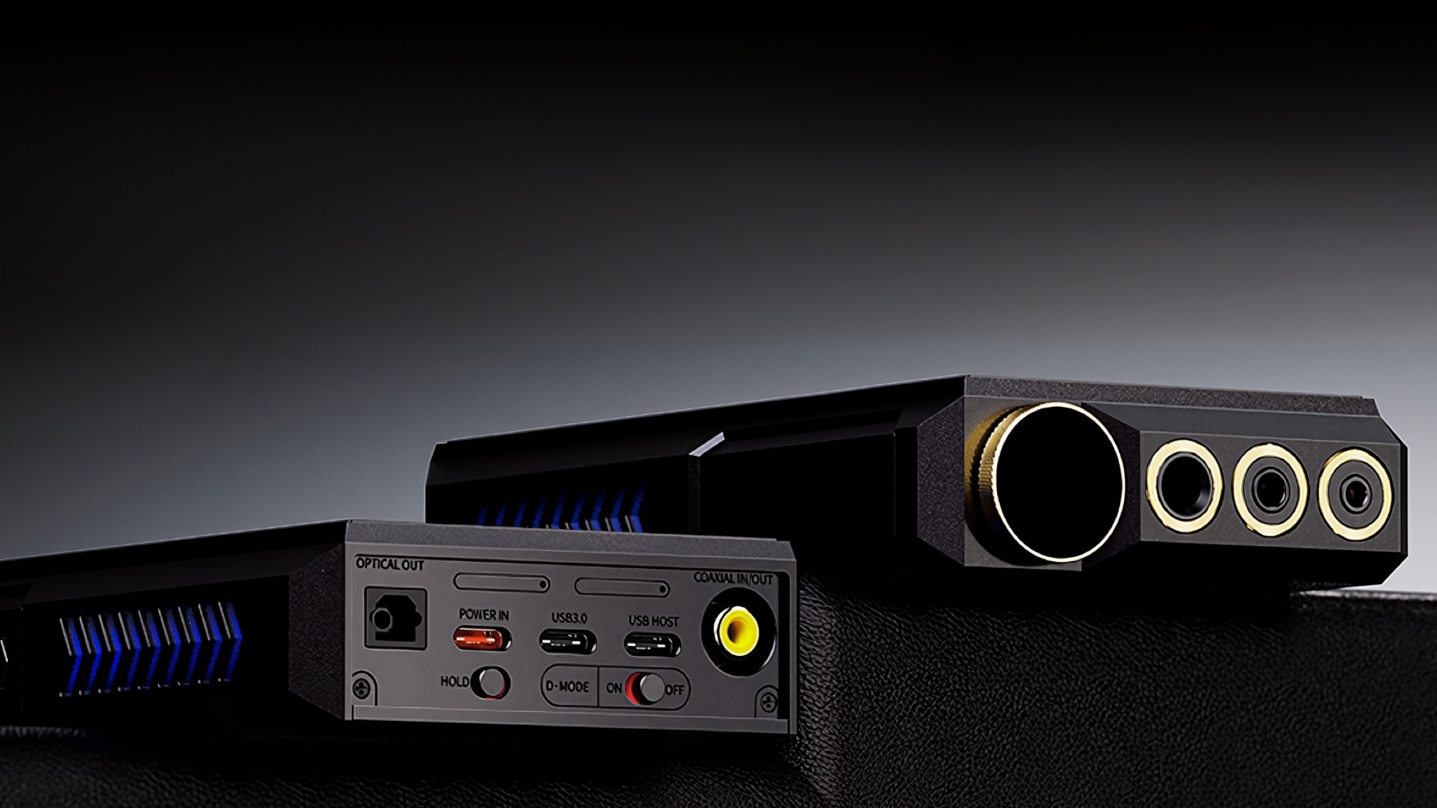 Two views showing the connections on the top and bottom of the FiiO M27 portable player. They're shot on a dark surface against a dark grey background