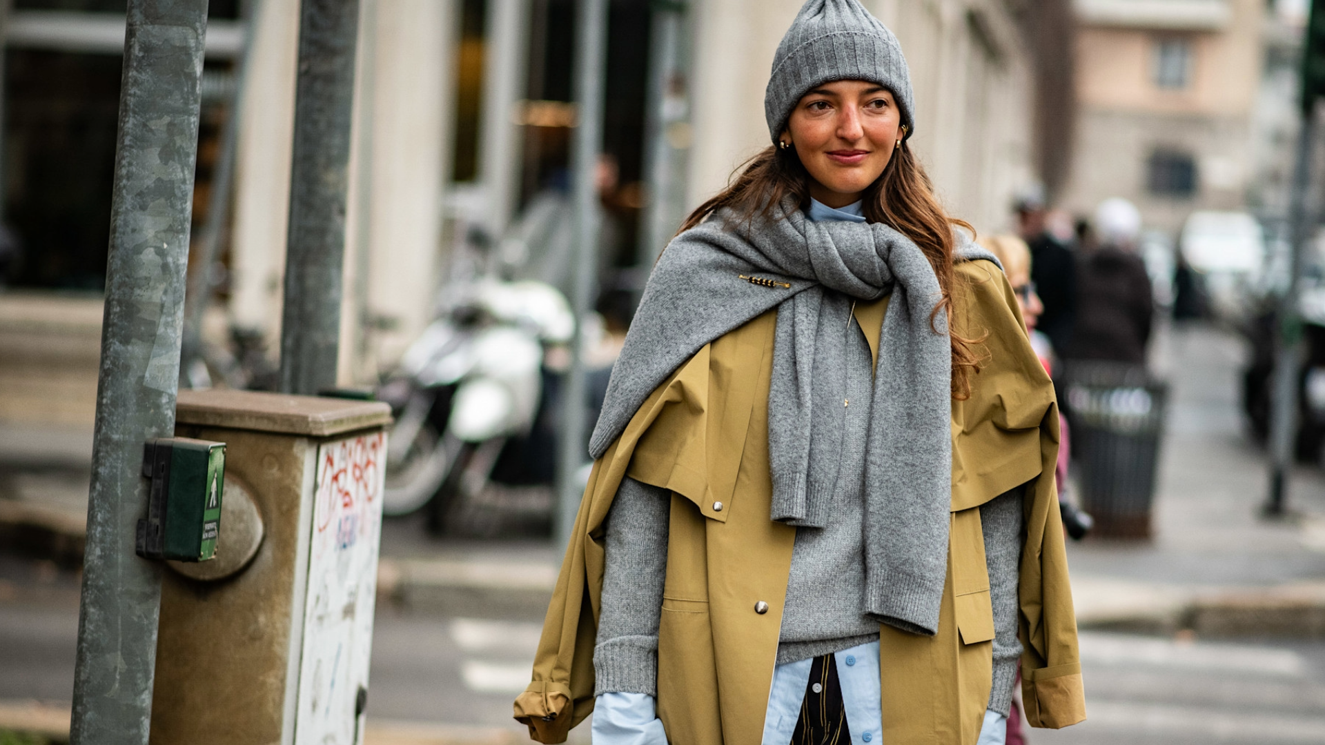 woman wearing a gray hat and trench coat