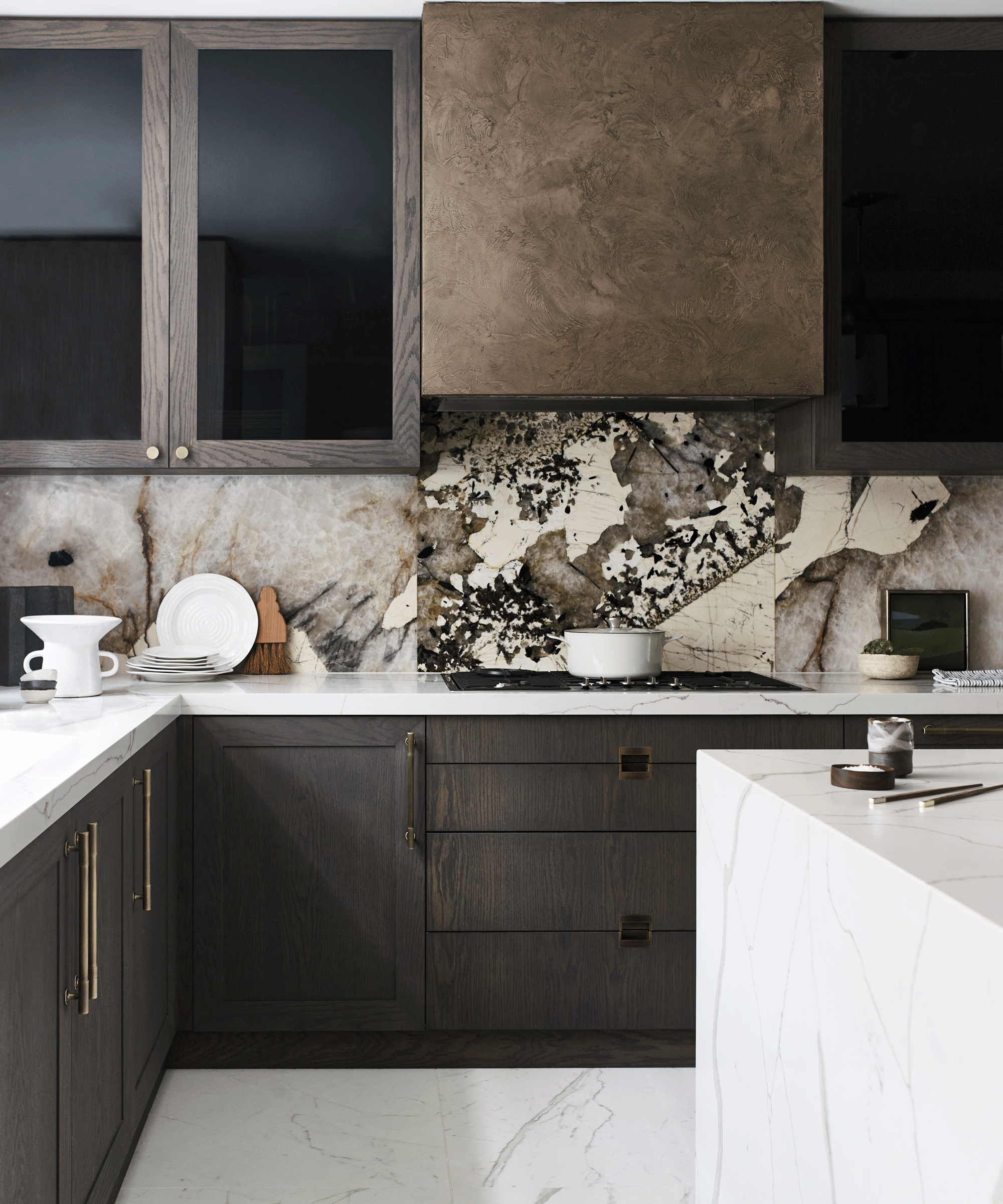 Wooden kitchen with marble splashback and smoked glass cabinets