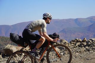 Male cyclist cycling in the Atlas Mountains in Morocco on a carbon gravel bike