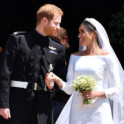 Prince Harry and Meghan Markle on their wedding day smiling at each other