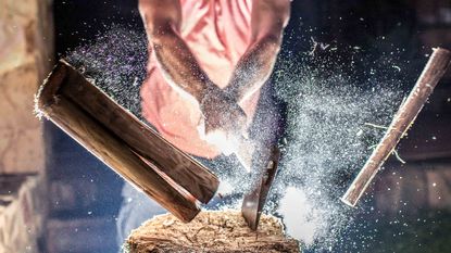 man chopping wood in half