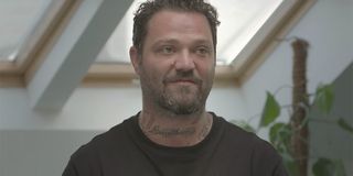 Bam Margera sits under a skylight