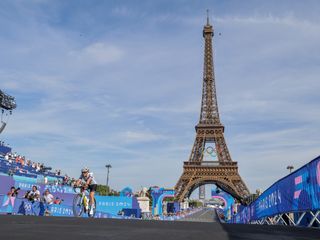 Paris, France - Women’s Road Race - Kristen Faulkner (USA) celebrates winning the Women's Road Race to become Olympic Champion in front of The Eiffel Tower