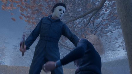 Michael holds a hatchet over Laurie as she kneels on the ground in front of him in Halloween the Game.