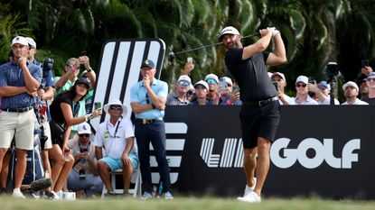 Dustin Johnson takes a shot at the LIV Golf Team Championship with Bryson DeChambeau and Greg Norman watching
