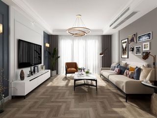 Herringbone effect luxury vinyl tile flooring in modern living room with coffee table, TV on white cabinet stand and neutral couch with colored cushions