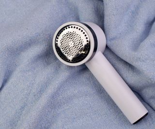 A fabric shaver on a blanket