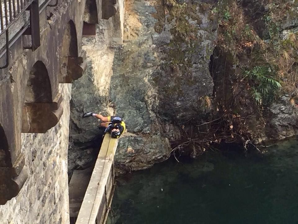 Arnold Fiek waits to be rescued after climbing out of the lake onto a narrow concrete strip