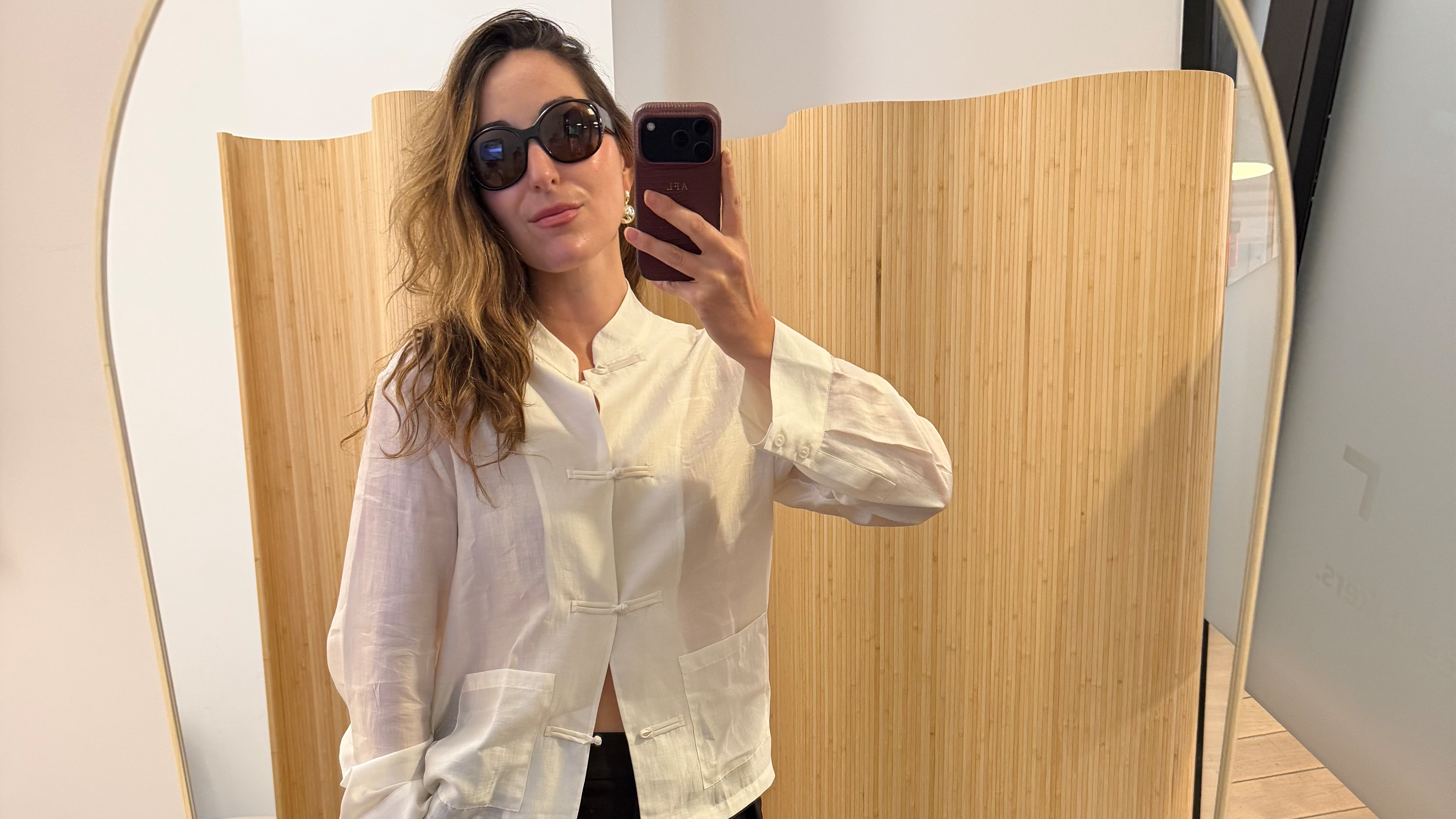 Anna LaPlaca wearing a Zara Satin-Effect Frog Closure Top.