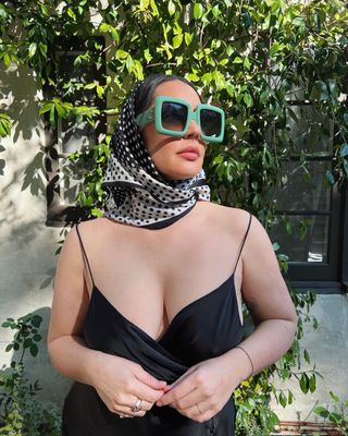 Pica Baroncini styles her oversized frames with a black and white head scarf