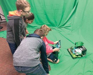 Students engaged in a green screen activity.