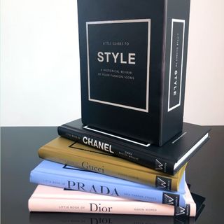 Dior, Prada, Gucci, and Chanel little guides to style , fanned out on top of each other